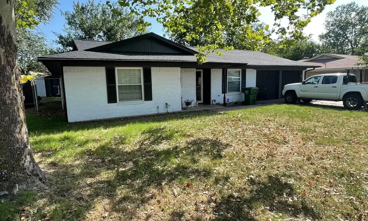Professional roofing crew working on a residential roof in Westport